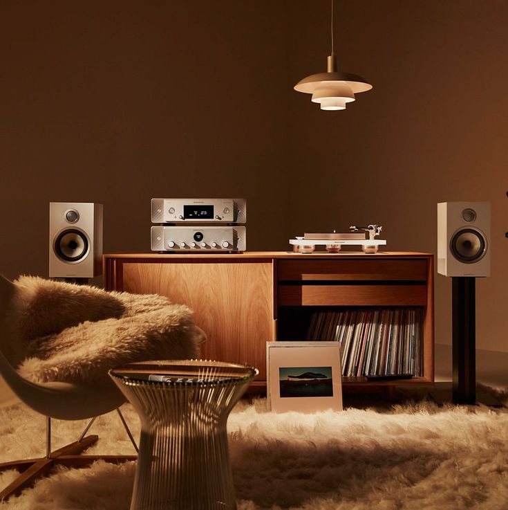 a living room filled with furniture and speakers