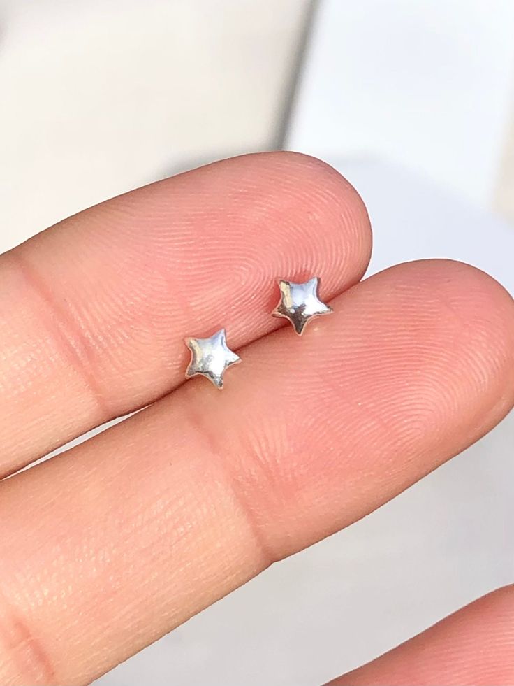 1 x pair of Tiny solid star stud earrings These delicate stud earrings are handmade of 925 sterling silver with a star design, bright and shine little cute one. Dimensions (approx): * 5x5 mm ✔ Nickel, Lead free & Hypoallergenic ✔ Perfect for sensitive skin ✔ Every order comes with a Beautiful gift box, ready for gifting WORLDWIDE SHIPPING All orders will ship within 1-2 working days once payment received * 3-5 working day for Australia wide * 10 -14 working days to USA * 14-20 working days REST Silver Star Stud Earrings, Silver Star Earrings Studs, Silver Earrings Design, Tiny Silver Earrings, Aesthetic Stud Earrings, Fun Stud Earrings, Star Earrings Aesthetic, Cute Silver Earrings, Earrings Studs Silver