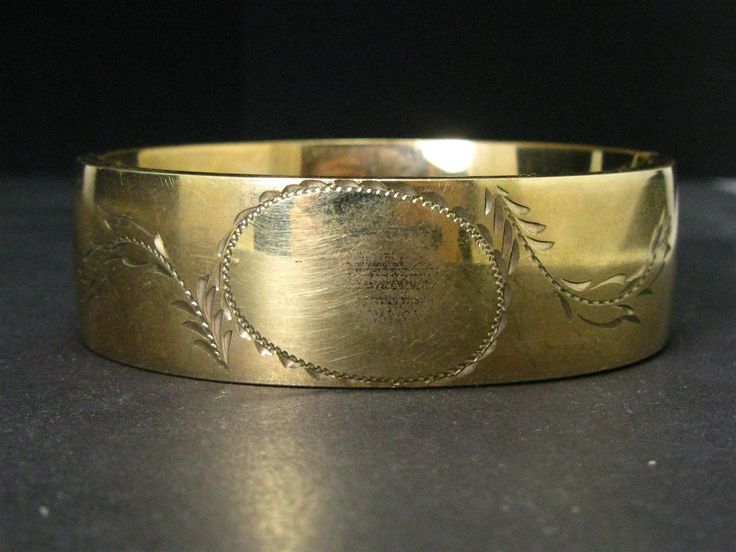 Cute victorian era bangle with engraved designs around the blank face. 19mm tall face. In great overall condition with no dents and very little wear. tested GF. Fits an approximate 7" wrist. Hinge and clasp works well. Antique Stamped Cuff Bracelet For Formal Occasions, Victorian Etched Cuff Bracelet For Wedding, Antique Engraved Yellow Gold Cuff Bracelet, Antique Gold Stamped Bracelets, Antique Gold Bracelets Stamped, Antique Gold Bracelets With Stamped Details, Vintage Engraved Cuff Bracelet For Formal Occasions, Vintage Engraved Cuff Bracelet For Formal Events, Antique Etched Cuff Bracelet For Formal Occasions