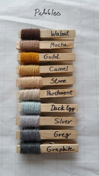 several different colored spools of thread sitting on top of each other