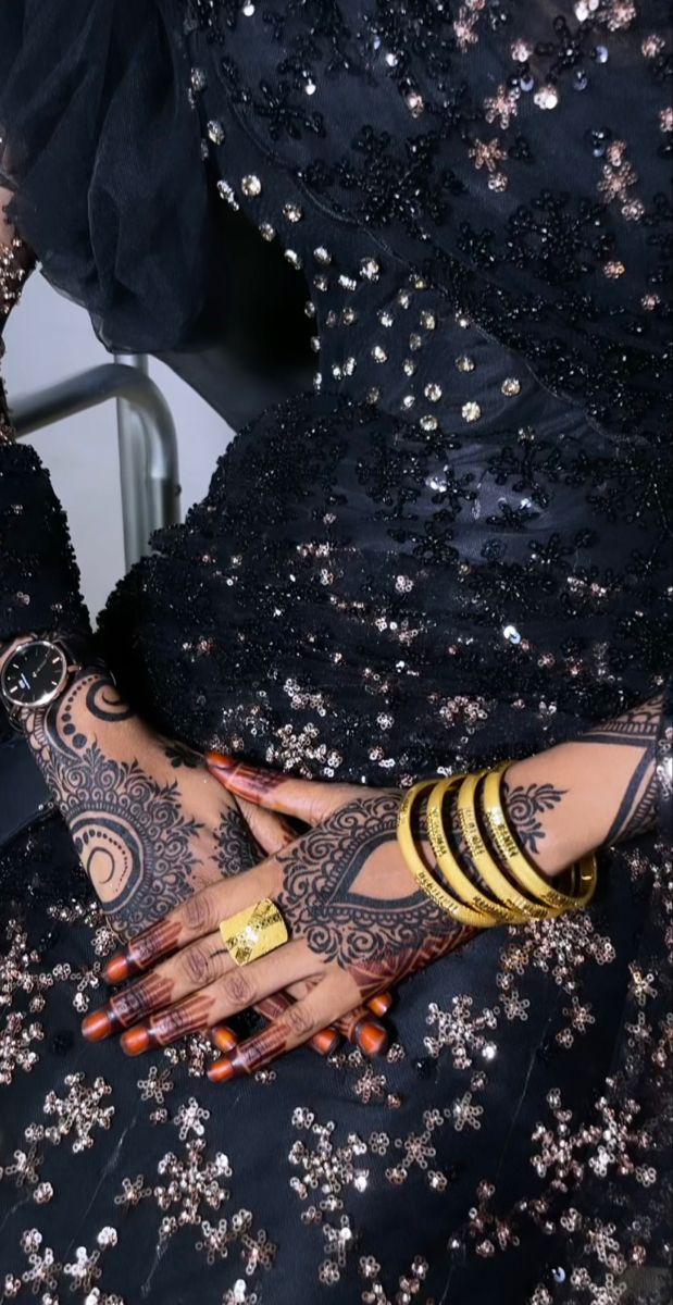 a woman with tattoos on her arm and hand