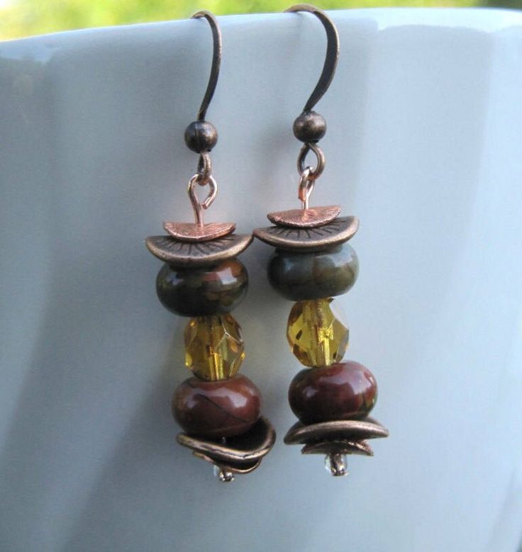 Earrings featuring the colors of Fall handmade with Red Creek Jasper beads, copper, antique copper, and Czech beads. This one inch drop earrings beautifully captures the colors of autumn with unique contrasting textures of stone, glass and metal.  The Fall colors of browns, reds and greens are captured in the semiprecious Red Creek Jasper stone and golden Czech fire polised beads. The vibrant rondelles colors are complimented by the antique copper spacers and the golden fire polished Czech glass Bronze Round Bead Copper Earrings, Bronze Copper Earrings With Round Beads, Vintage Copper Beaded Earrings For Gift, Bronze Copper Earrings With Dangling Beads, Brown Copper Beaded Earrings With Dangling Beads, Brown Copper Beaded Dangling Earrings, Brown Copper Beaded Earrings, Bronze Copper Jewelry With Dangling Beads, Brown Copper Beaded Earrings For Gift