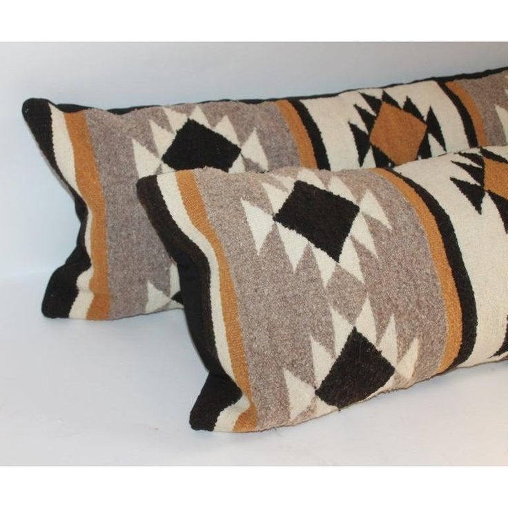 two brown and white pillows sitting next to each other