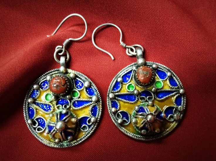 Magnificent Algerian earrings from the Grand Kabyle region in solid silver enamelled in blue and yellow color, inlaid with a cabochons of real coral. ** Height: 5.6 cm. ** Width: 3.3 cm. ** Material: Sterling Silver 925, Genuine Coral. ** Weight: 17.7 grams. ** Origin: Grand Kabyle Region 1970s - Algeria. ** Shipping: Free worldwide by DHL. I am always open to offers for one of my items, so please contact me if you would like to make an offer. Do not hesitate to contact me for any questions. All Ethnic Earrings, Earrings Boho, Silver Enamel, Yellow Color, Jewelry Earrings Dangle, Dangle Drop Earrings, Dangle Earrings, Etsy Accessories, Jewelry Earrings