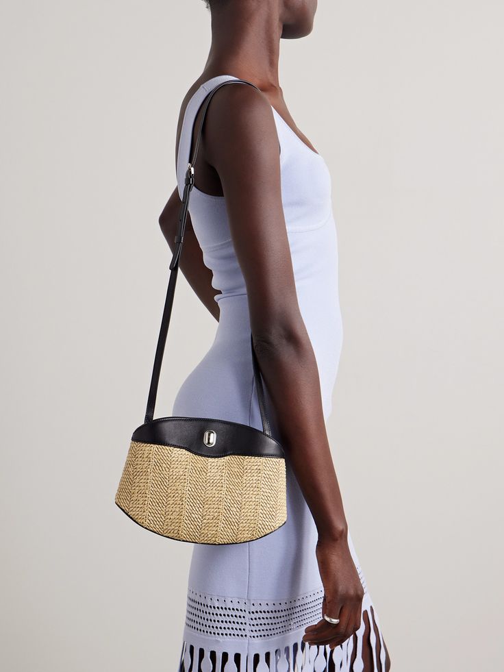 Savette's 'Tondo' bag is defined by its distinctive curved shape. Ideal for summer, it has been meticulously handcrafted from raffia and leather and is punctuated with the brand's signature silver-tone hardware. It's perfectly sized to fit your sunglasses, cardholder and a compact for touch-ups. Elegant Straw Bag With Round Handle In Natural Color, Evening Woven Leather Bag In Natural Color, Evening Bags In Woven Leather Natural Color, Evening Bag With Woven Leather In Natural Color, Evening Bag In Natural Woven Leather, Luxury Evening Straw Bag With Leather Handles, Luxury Straw Bag With Leather Handles For Evening, Evening Shoulder Bag With Braided Handles In Natural Color, Evening Leather Shoulder Bag In Natural Color