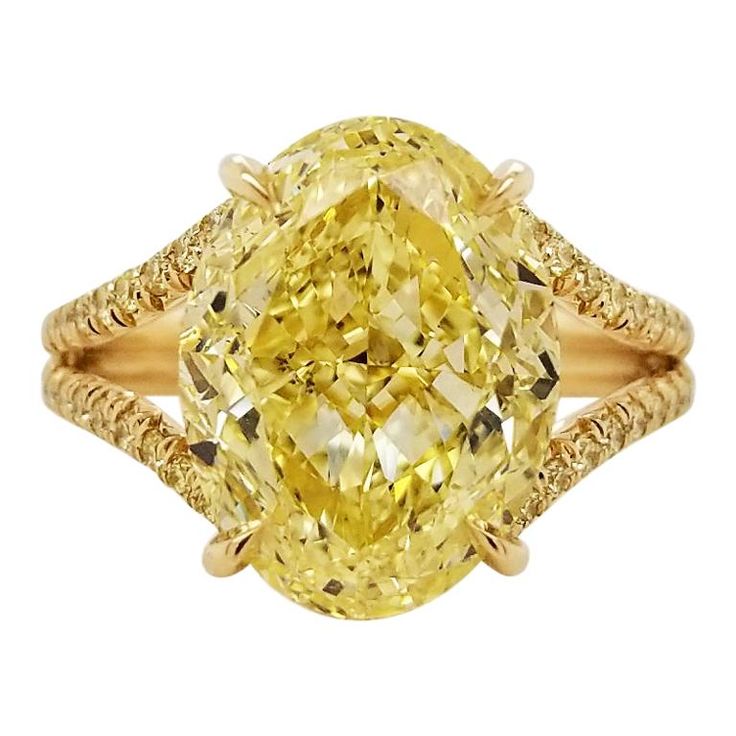 From SCARSELLI, a simply important ring featuring a 6.00 carats Fancy Intense Yellow Oval cut diamond (GIA VS2 Clarity Certificate 5202490787) surrounded by 0.48 carats of Fancy Intense Yellow Round brilliant diamonds in a coordinating handmade mounting of 18k yellow gold. This ring may be sized or re-designed with Scarselli to suit the client's specifications. Should a client wish to customize settings to personalize the look, such as changing side stones or bands, we are happy to accommodate s Luxury Oval Yellow Sapphire Diamond Ring, Exquisite Yellow Oval Rings, Luxury Vintage Yellow Rings, Luxury Yellow Sapphire Gemstone Ring, Luxury Yellow Sapphire Ring, Fine Jewelry, Yellow Diamond Ring, Canary Diamond, Flower Diamond Ring, Marquise Shape Diamond