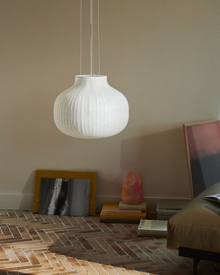 a white light hanging from a ceiling in a living room