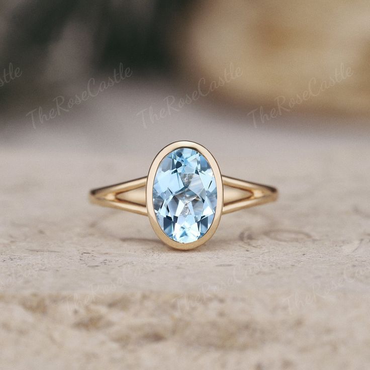 Unique topaz engagement ring yellow gold solitaire blue gemstone ring split shank bezel ring custom topaz ring handmade jewelry gift for her ITEM DETAILS ●Available in yellow, white or rose solid 10k, 14k or 18k gold. This ring can be made in Platinum. ❀❀Center Stone: Topaz Shape: Oval shape Size: 6x9mm Band width approx 1.7mm I am happy to custom the ring in this unique look and intricately textured finish. Click the link to: https://www.etsy.com/listing/1472822075/unique-moissanite-engagement-ring-long Visit my shop for more jewelry: https://www.etsy.com/shop/TheRoseCastle ❀Production ---- This ring is handmade and very good quality! Please allow 2-4 weeks for production. It can be made to any ring size.  ❀Engraving service We accept the engraving order, leave a note when placing an orde Minimalist Jewelry With Center Stone For Formal Occasions, Minimalist Formal Jewelry With Center Stone, Minimalist Jewelry With Center Stone In Round Band, Elegant 14k Gold Topaz Birthstone Ring, 14k Gold Jewelry With Bezel Setting, Minimalist Jewelry With Center Stone, Timeless Solitaire Ring Jewelry, Oval Aquamarine Fine Jewelry, Jewelry With Round Cut Bezel Setting