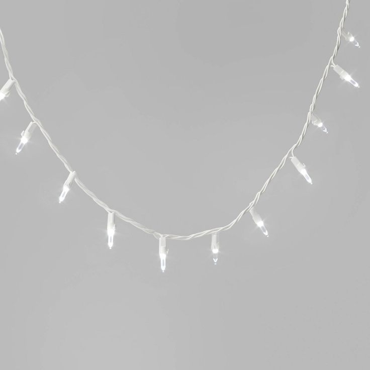 white christmas lights are hanging on a string