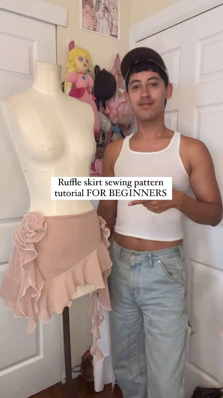 a man standing next to a mannequin wearing a white tank top with ruffles on it