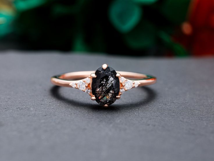 a black diamond ring sitting on top of a table