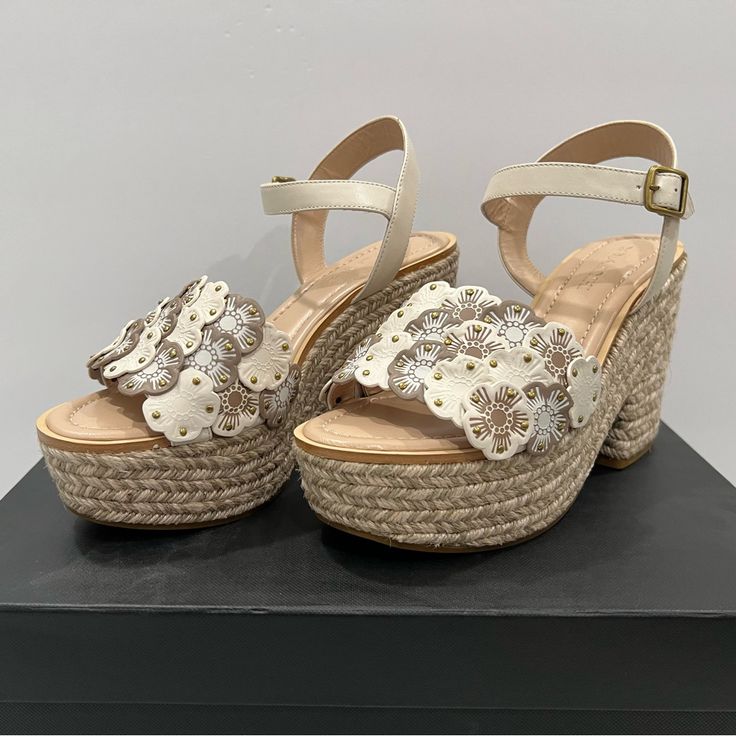 Coach Jae Leather Peep Toe Casual Ankle Strap Sandals Size 8.5 Signature Tea Roses Highlighted With Gilded Studs Bloom At The Vamp Of A Quarter-Strap Sandal Set On A Jute-Wrapped Platform And Chunky Heel. New In Box, Never Worn. 4 1/4" Heel; 2" Platform 3" Strap Height Adjustable Strap With Buckle Closure Leather Upper And Lining/Synthetic Sole Currently Selling On Ebay For $212. Coach Leather Platform Sandals, Coach High Heel Sandals For Spring, Coach Spring Sandals With Open Heel, Coach Sandals For Spring With Open Heel, Coach Summer Heels With Heel Strap, Coach Open Heel Sandals For Spring, Coach Closed Toe Heels For Spring, Coach High Heels For Spring, Embellished Block Heel Sandals For Spring