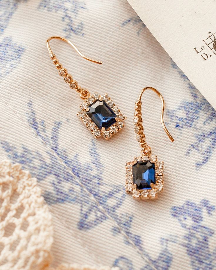 Experience the beauty of these Renaissance Earrings, featuring faux glass sapphires. These stunning earrings are sure to add a touch of elegance to any ensemble. Perfect for special occasions or everyday wear. Sapphire faux glass gold plated brass earrings. Glamorous Gold Plated Crystal Earrings For Party, Elegant Gold-plated Crystal Earrings For Party, Elegant Gold Plated Crystal Earrings For Party, Luxury Drop Cluster Earrings For Evening, Luxury Cluster Drop Earrings For Evening, Luxury Cluster Drop Earrings For Evening Occasions, Luxury Sapphire Earrings For Formal Occasions, Glamorous Yellow Gold Earrings For Party, Glamorous Gold Earrings For Formal Occasions