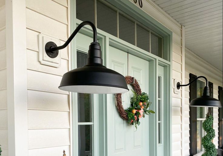 the front door is decorated with wreaths and lights