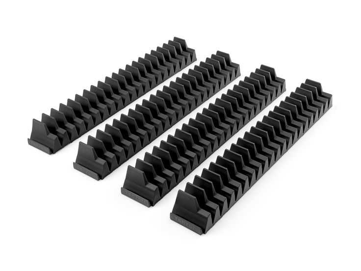 four black plastic pieces on a white background