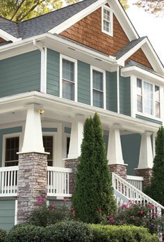 a house with blue siding and white balconies