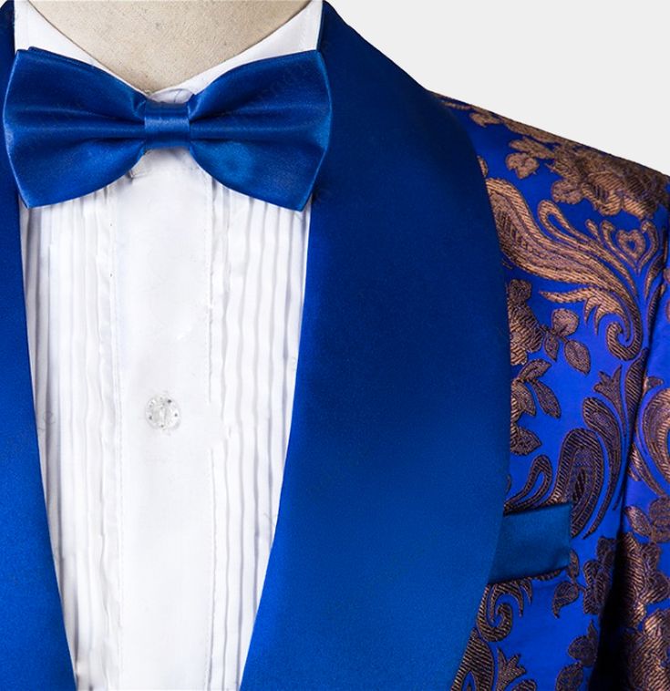 Turn some heads at your next formal event with this 3 pieces royal blue tuxedo. Take your formal wardrobe to the next level and indulge yourself with class, style, and sophistication when you add this tux to your collection. The royal blue hues gleam enticingly, while the golden embroidery gleams in a mischievous manner. The mix of blue and gold creates a mesmerizing effect that impresses right from the start. The pattern is a combination of floral and paisley motifs – the detailing is exquisite Royal Blue Tuxedo Suit For Party, Royal Blue Notch Lapel Suits For Party, Luxury Three-piece Suit For Party, Royal Blue Tuxedo Blazer For Party, Elegant Royal Blue Tuxedo With Suit Collar, Royal Blue Tailored Party Suit, Fitted Blue Tuxedo For Semi-formal Occasions, Tailored Royal Blue Party Suit, Semi-formal Fitted Blue Tuxedo