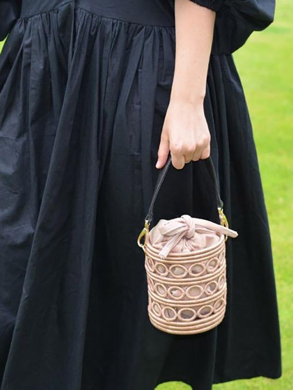 The Urugori Bag is artfully constructed to create a unique yet timeless statement. Handcrafted by artisans in Rwanda, the bucket bags are made by wrapping sisal around bunches of sweetgrass. Hand dyed a soft pink and complete with faux leather handle and a removable organic cotton pouch. This one of a kind woven handbag can be styled casually or dressed up depending on the occasion. The perfect wedding outfit or travel accessory to see you through the Spring-Summer season. Beige Handwoven Top Handle Bucket Bag, Beige Woven Bucket Bag With Round Handle, Eco-friendly Woven Bucket Bag With Top Handle, Daily Use Handheld Bucket Bag With Bamboo Handle, Daily Handheld Bucket Bag With Bamboo Handle, Straw Tote Bucket Bag With Detachable Handle, Handheld Bucket Bag With Bamboo Handle, Brown Bucket Bag With Braided Handles, Brown Bucket Bag With Braided Round Handles