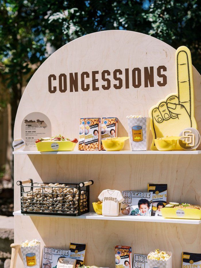 a wooden sign that says concessions on it next to other signs and food items