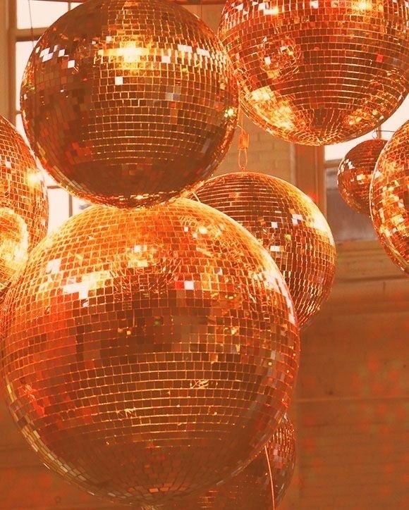 many shiny disco balls hanging from the ceiling