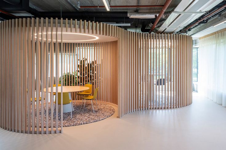 an office with wooden partitions and round table