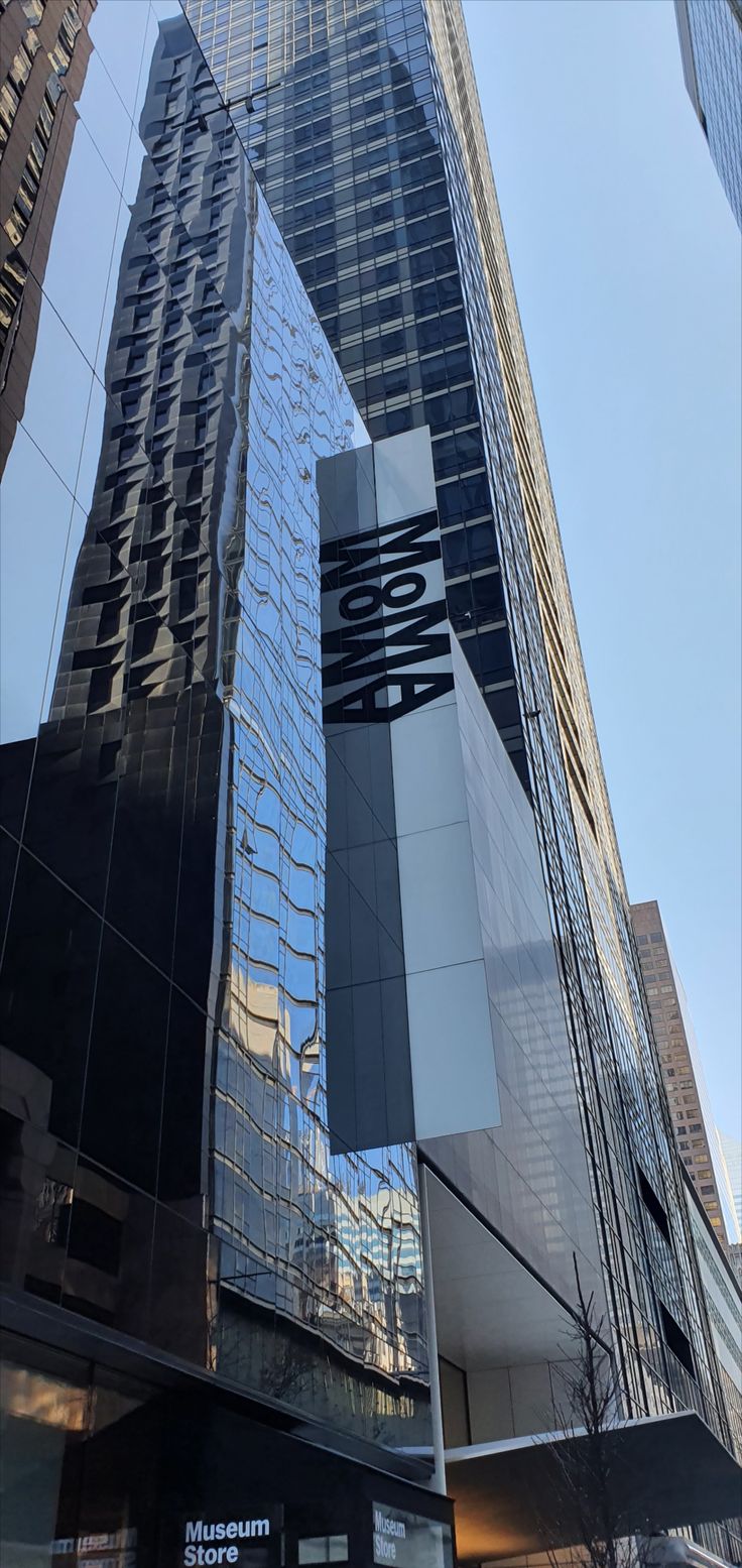 the reflection of skyscrapers in the windows of another building