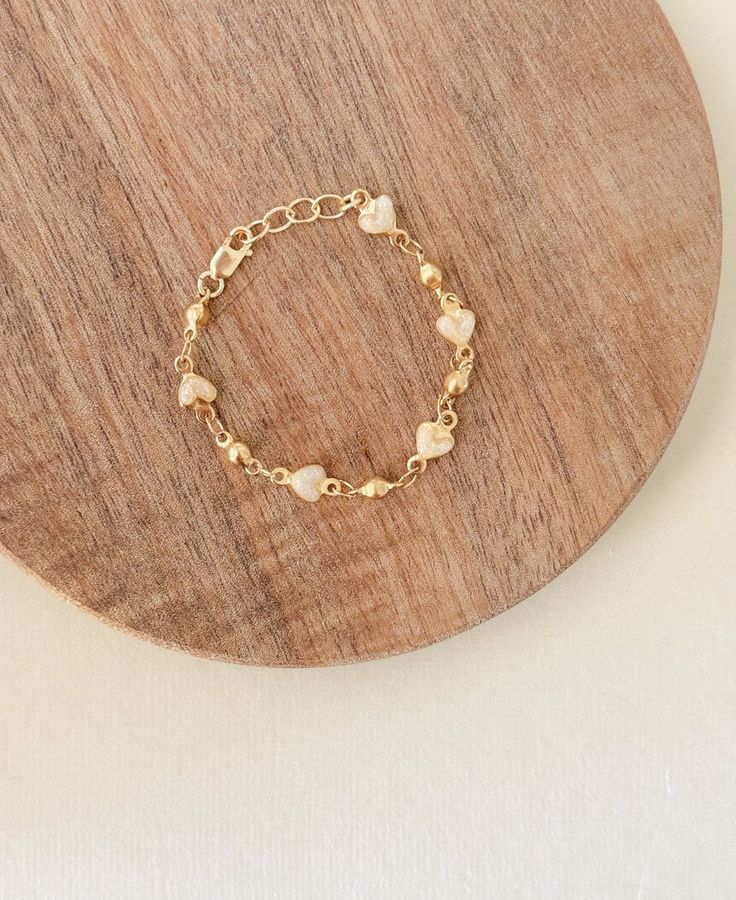 This is such a beautiful & whimsical bracelet made for all ages, 4mm shimmery enamel hearts with beautiful strong 14k gold filled  chain, this is a beautiful statement piece but is dainty enough for everyday wear. This would layer beautifully with any other gold piece and it's a perfect gift for moms, kids, babies, any celebrations this is made with 14k gold filled findings and can be worn daily, but be sure to keep away from harsh chemicals, soaps &  fragrances for long lasting wear, continued Adjustable Dainty Gold Bracelet With Heart Charm, Adjustable Heart Charm Chain Bracelet For Wedding, Adjustable Wedding Chain Bracelet With Heart Charm, Dainty Gold Beaded Bracelets With Extender, Dainty Gold Beaded Bracelet With Extender, Delicate Gold Rosary Bracelet Gift, Dainty Gold Bracelet With Heart Charm, Dainty Gold Rosary Bracelet With Adjustable Chain, Dainty Gold Plated Bracelet With Extender