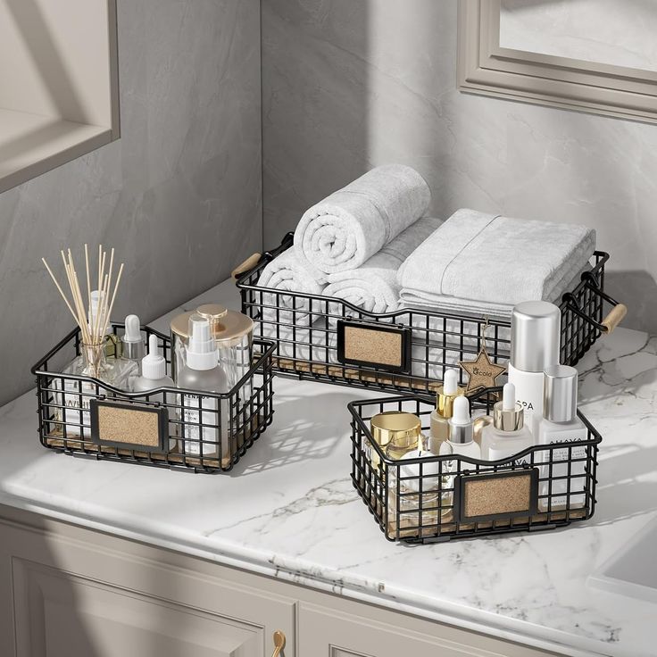 two trays that have towels and candles in them on a marble countertop next to a bath tub