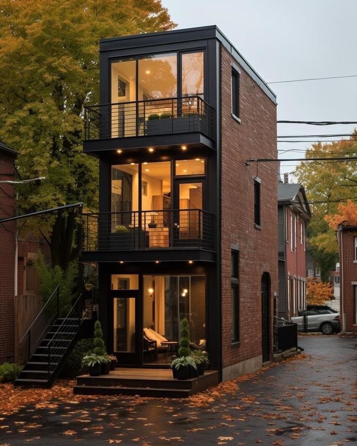 a two story house with lots of windows and balconies on the second floor