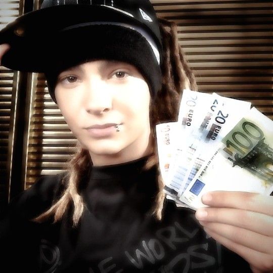 a woman wearing a hat and holding money