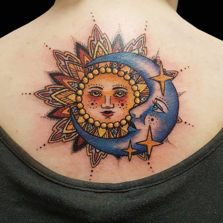 a woman with a sun and moon tattoo on her back