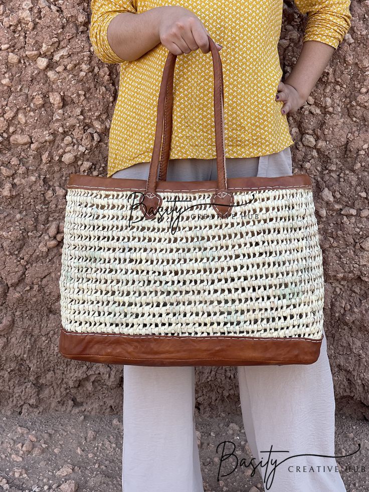 Prepare yourself for endless beach days and summer escapades with our chic Large Straw Beach Tote Bag. This versatile accessory is a must-have for beach enthusiasts and fashion aficionados alike. Expertly crafted from a fusion of straw and high-quality leather, this beach tote bag offers the perfect blend of durability and style. Its capacious interior provides ample space to stow all your essentials, from beach towels to sunscreen and more. Whether you're leisurely strolling along the coastline Daily Use Beach Bag Satchel For Beach Season, Daily Use Beach Season Satchel Beach Bag, Daily Use Satchel Beach Bag, Daily Use Beach Season Satchel Bag, Summer Rectangular Shoulder Bag For Travel, Summer Style Rectangular Travel Shoulder Bag, Summer White Rectangular Bucket Bag, White Rectangular Summer Bucket Bag, Summer Bags With Leather Handles For Daily Use