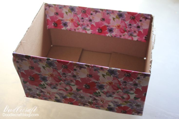 an open box with flowers on it sitting on a table