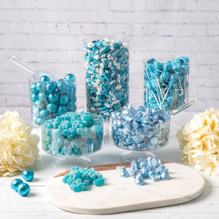 blue and white candies are arranged on a platter next to other candy items