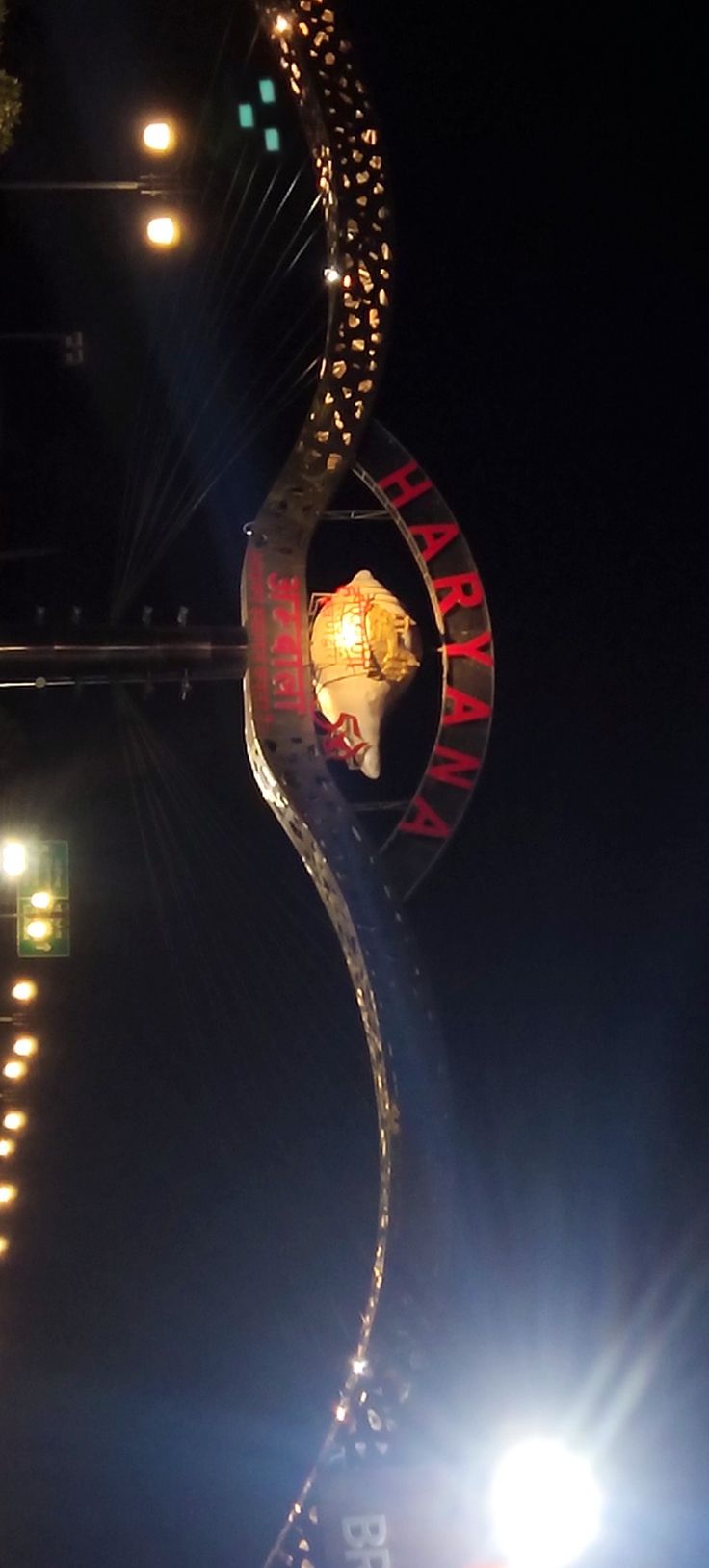 a person on a snowboard does a trick in the air at night with bright lights