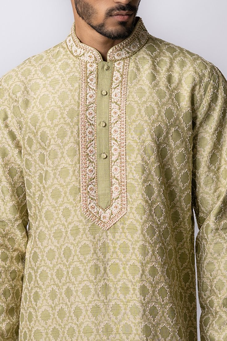 Olive kurta with floral print, zardozi embroidery and front buttons. Paired with churidar.
Component: 2
Pattern: Embroidered,Printed
Type Of Work: Floral
Neckline: Mandarin
Sleeve Type: Long Sleeves
Fabric: Tussar
Color: Green
Other Details: 
Front buttons
Zardozi work
Occasion: Puja, Wedding - Aza Fashions Kurta Set Men, Zardozi Work, Zardozi Embroidery, Kurta Set For Men, Churidar, Kurta Set, Aza Fashion, Sleeve Type, Krishna