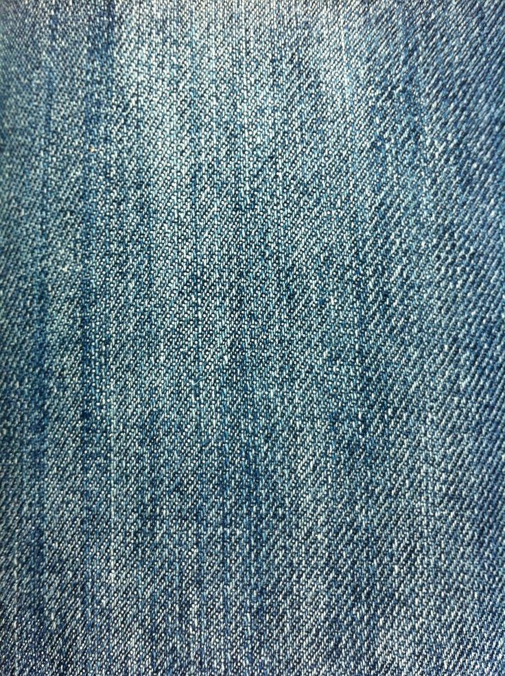 an up close view of blue jeans textured with white stitchs on the side