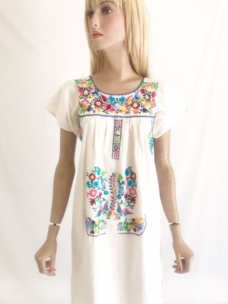 Beautiful vintage 70's Mexican embroidered dress. Raw cotton fabric. Hand embroidered. Vibrant colors. Hard to find, shorter length. In great vintage condition Size. Fits small to x small approx Vintage Dresses With Multicolor Embroidery For Spring, Spring Cotton Dress With Embroidered Border, Spring Embroidered Dress With Multicolor Machine Embroidery, Vintage Multicolor Embroidered Dress, Vintage Cotton Dress With Floral Embroidery, Vintage Short Sleeve Embroidered Dress With Floral Design, Vintage Cotton Embroidered Dress With Floral Embroidery, Vintage Short Sleeve Floral Embroidered Dress, Short Sleeve Cotton Dresses With Embroidered Border