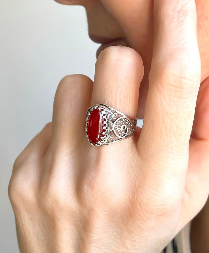 "Carnelian Gemstone 925 Sterling Silver Artisan Made Handcrafted Filigree Art Cocktail Ring Ring Face Length is 0.65\" and Width is 0.30\" Natural Carnelian Gemstone is 7X14 mm oval cabochon cut. This metal embroidery filigree ring is oxidized and highly polished. Comes with velvet pouch and luxurious gift box. Filigree is made of delicate metal strands that have been skillfully fashioned to create an outstanding combination of old and modern art. Originating in Mesopotamia, Anatolia. It is made Silver Carnelian Ring As A Gift, Silver Carnelian Rings For Gift, Spiritual Carnelian Ring Jewelry, Antique Carnelian Ring As Gift, Antique Carnelian Rings For Gifts, Antique Carnelian Ring As A Gift, Silver Carnelian Jewelry For Anniversary, Vintage Silver Carnelian Rings, Antique Carnelian Ring For Gift