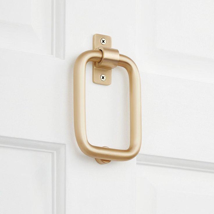 a gold door handle on a white door