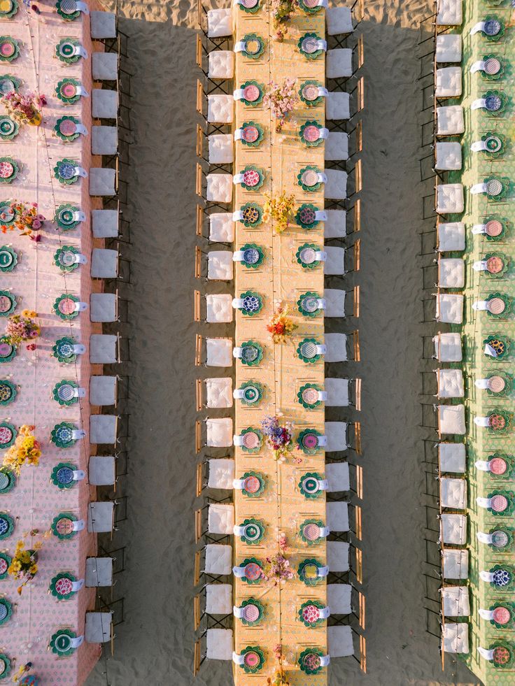 an aerial view of tables and chairs set up on the beach for a wedding reception