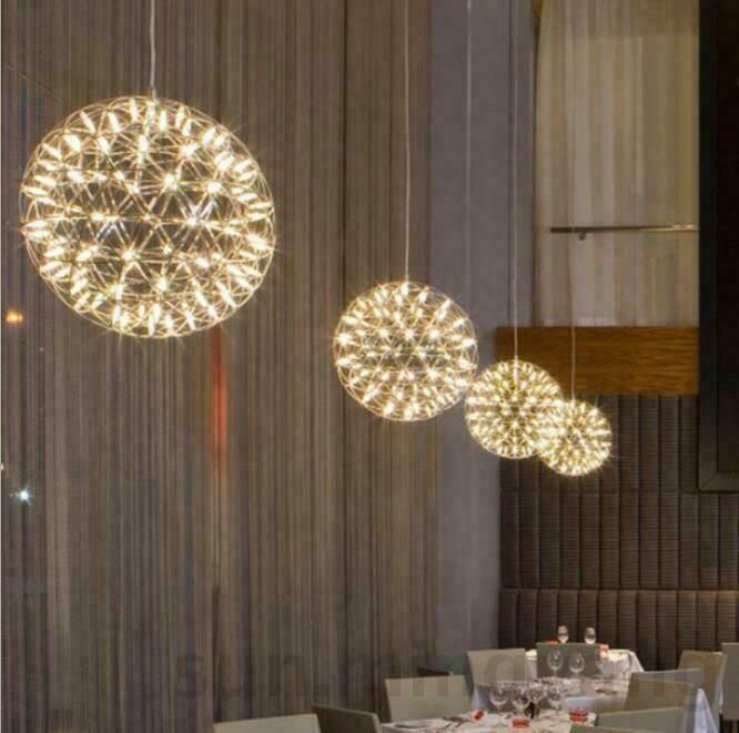 a dining room filled with lots of tables and chairs covered in white tablecloths