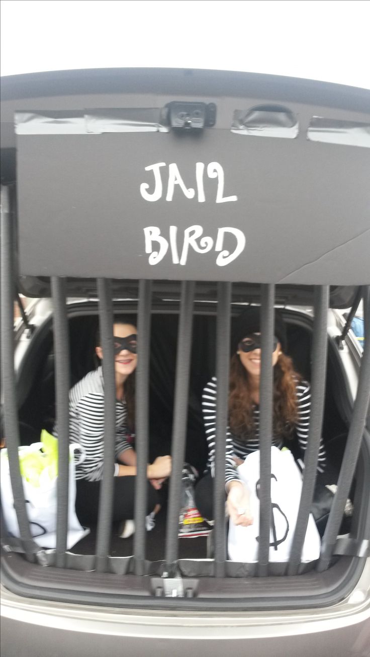 three women sitting in the back of a car