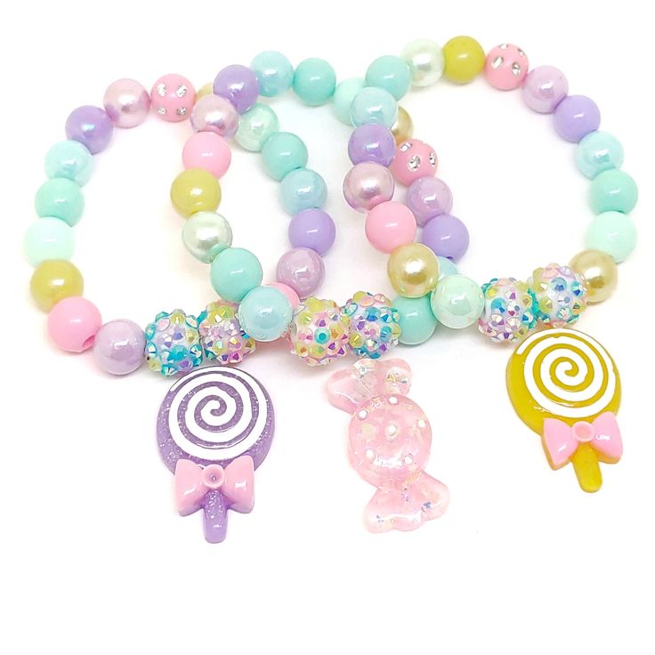 These adorable bracelets are the perfect favor for your little one's candy themed party! Each bracelet features a bright rainbow swirl clay lollipop charm, resin rhinestone beads and an assortment of bright rainbow 10mm acrylic beads strung with durable stretch cord. Each bracelet will arrive individually packaged in organza bags. Please select the number of bracelets and bracelet size needed from the drop down menu. Please message me if you have any questions. To be the first to know about new Colorful Cute Party Jewelry, Cute Plastic Beaded Bracelets For Birthday, Cute Multicolor Charm Bracelet For Parties, Playful Pink Charm Bracelet For Birthday, Whimsical Pink Charm Bracelet For Birthday, Sweet Beaded Bracelets For Birthday, Sweet Round Beaded Bracelets For Birthday, Sweet Beaded Bracelets With Round Beads For Birthday, Whimsical Pink Bracelets For Birthday