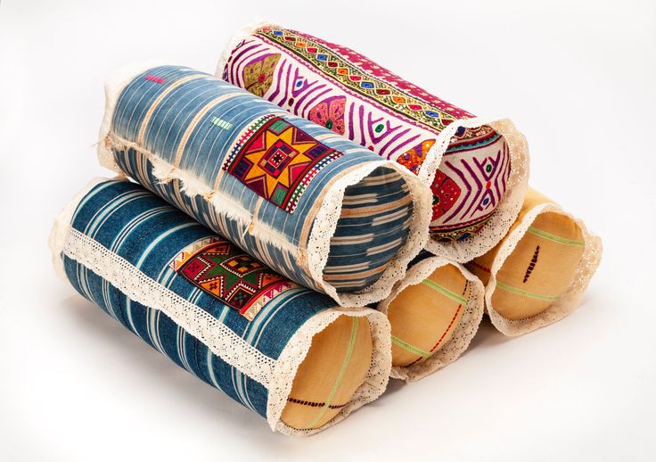 three rolls of decorative fabric sitting on top of each other