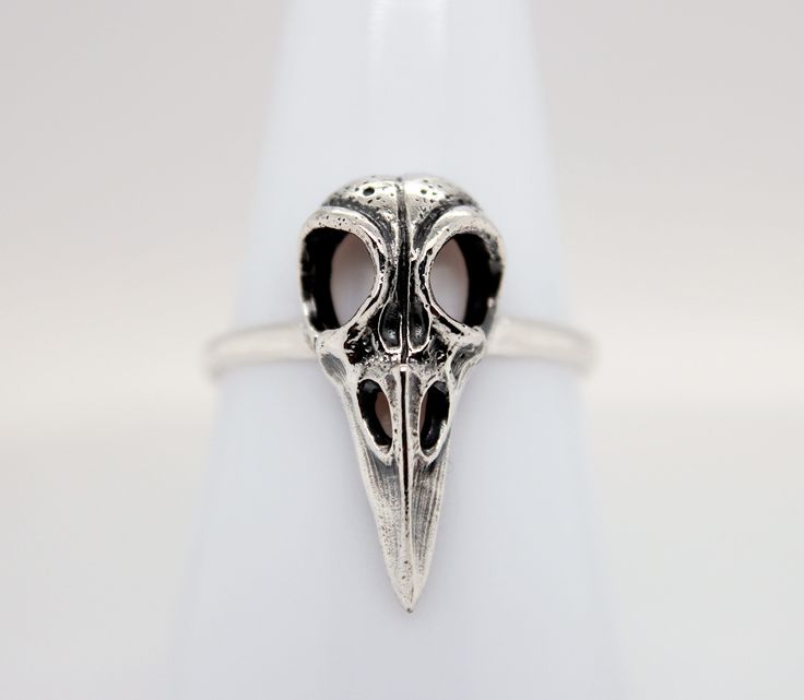 Sterling Silver Raven Skull Ring. This sterling silver bird skull ring features a hollow 3D design with oxidized details. This ring looks great on its own or as part of an on-trend stacked look. Finish may very slightly from pictures.  Each order comes with a polishing cloth, anti-tarnish strip, jewelry/candle care instructions and a custom jewelry box. PLUS  a goodie bag with stickers or book mark, wax melts, tumbled or raw gemstone and a coupon code for your next order * Materials: .925 Sterli Custom Jewelry Box, Raven Skull, Bird Skull, Jewelry Candles, Ring Antique, Skull Ring, Skull Design, Raw Gemstones, Antique Rings