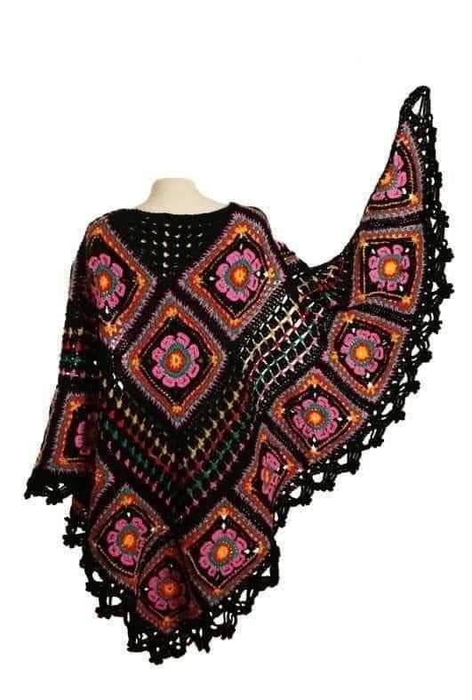 a black and pink crocheted shawl on a mannequin