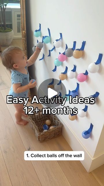 a baby standing next to a wall with magnets on it's side and the words easy activity ideas for 12 months old