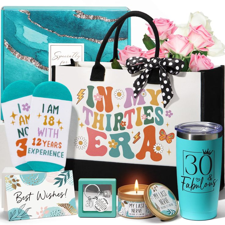 an assortment of items from the 30th anniversary gift set, including a teal tote bag and pink roses