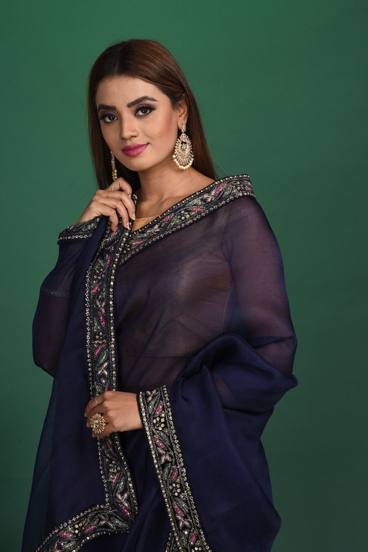 Slay with your elegance at parties and festive occasions in this stunning navy blue organza sari with embroidered border. It comes with a heavy embroidery saree blouse. Shop designer sarees online in USA from Pure Elegance. Disclaimer: The shown stitched blouse on the model is for display purpose only. The saree comes with a matching blouse and finished with fall and piko. Blue Organza Pre-draped Saree With Dupatta, Blue Tissue Silk Salwar Kameez With Zari Work, Festival Blue Tissue Silk Salwar Kameez, Designer Blue Sharara With Embroidered Border, Blue Tissue Silk Anarkali Set With Dupatta, Designer Blue Tissue Silk Salwar Kameez, Blue Anarkali Set With Dupatta In Tissue Silk, Blue Organza Blouse Piece With Cutdana, Blue Tissue Silk Salwar Kameez With Resham Embroidery